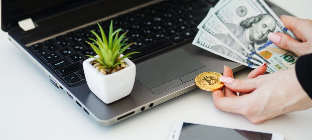 Close-up woman buying online with cryptocurrency concept, woman holding golden crypto coin.