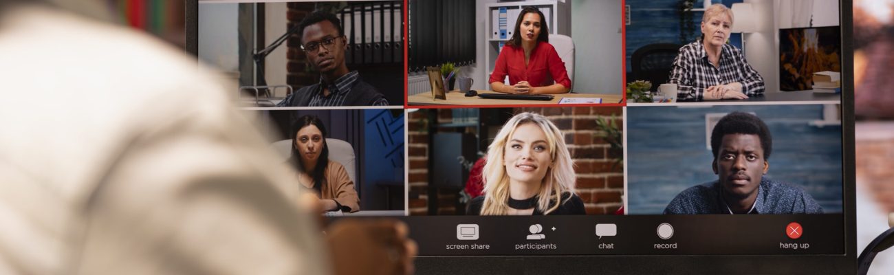 Remote worker speaking with coworkers during videocall from home desk, organizing calendar appointments. Teleworker doing remote teleconference meeting with colleagues, close up